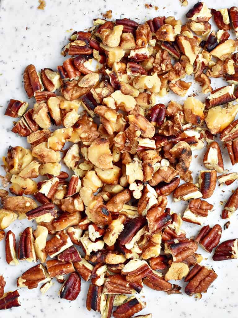 Toasted chopped walnuts and pecans, close up view.