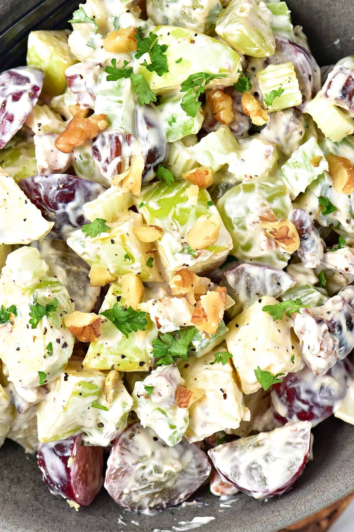 Close up of Waldorf salad with grapes and walnuts.