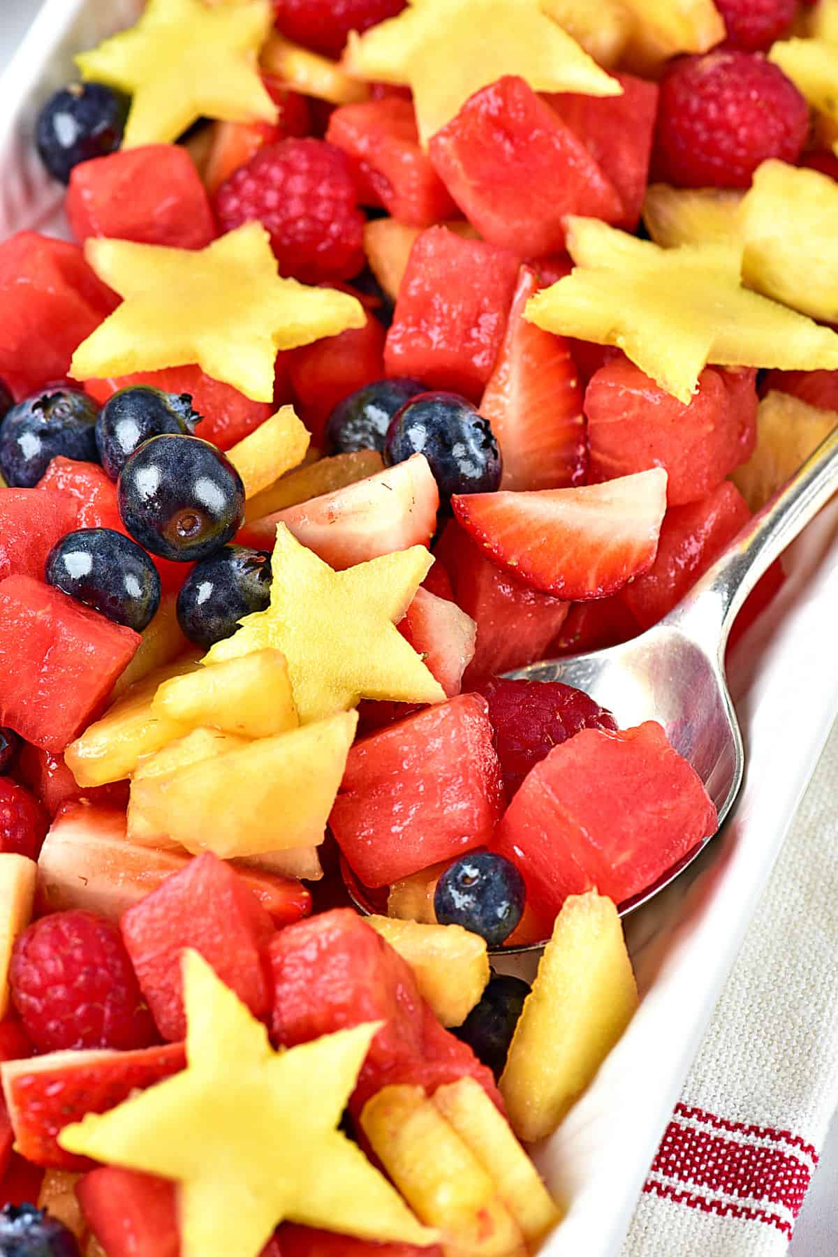 Close up fruit salad for patriotic days. Silver spoon.