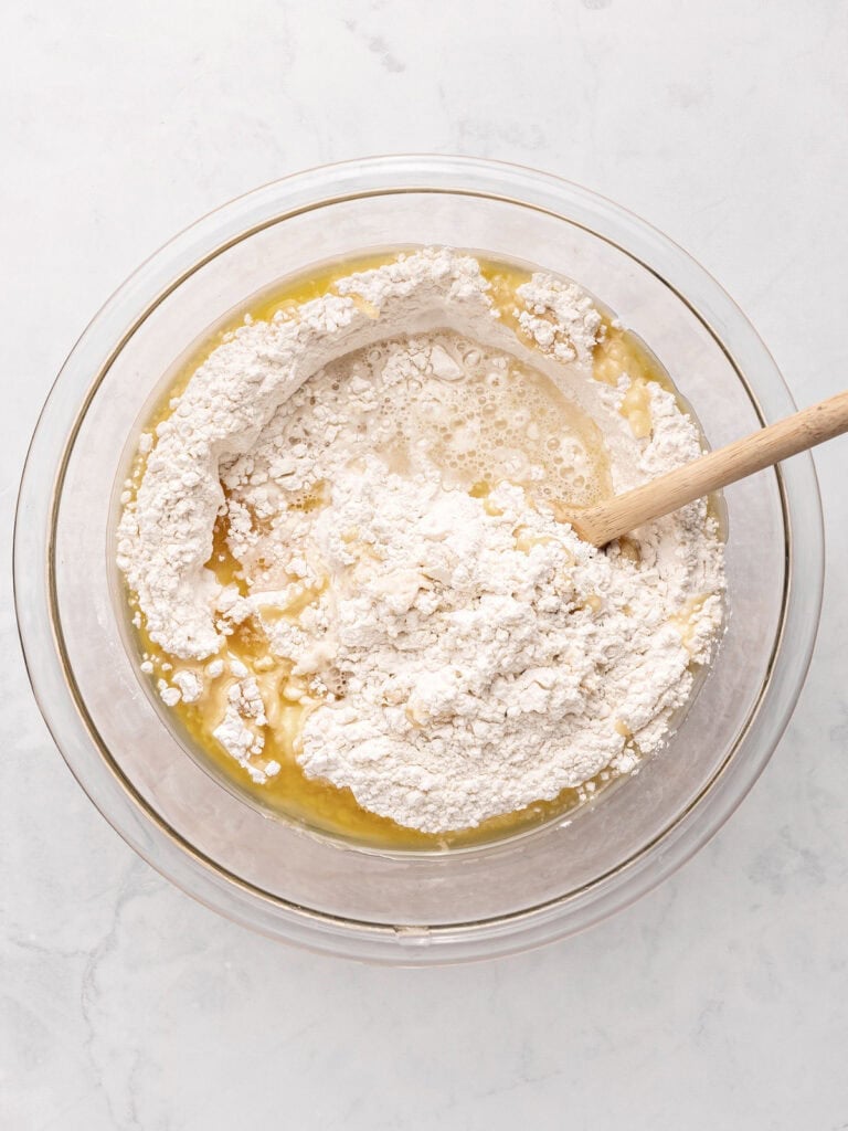 Flour mixture and melted fat in a glass bowl. Light gray background.