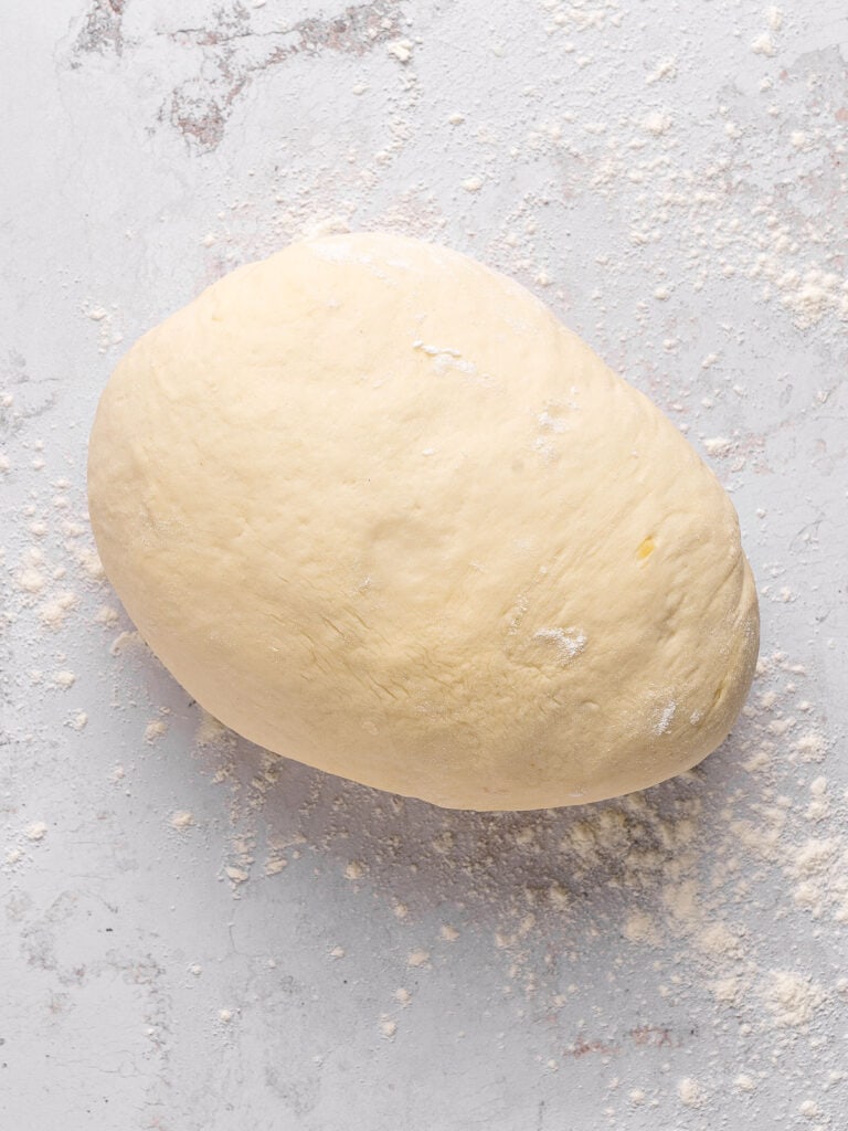 White bread dough on a light gray background.