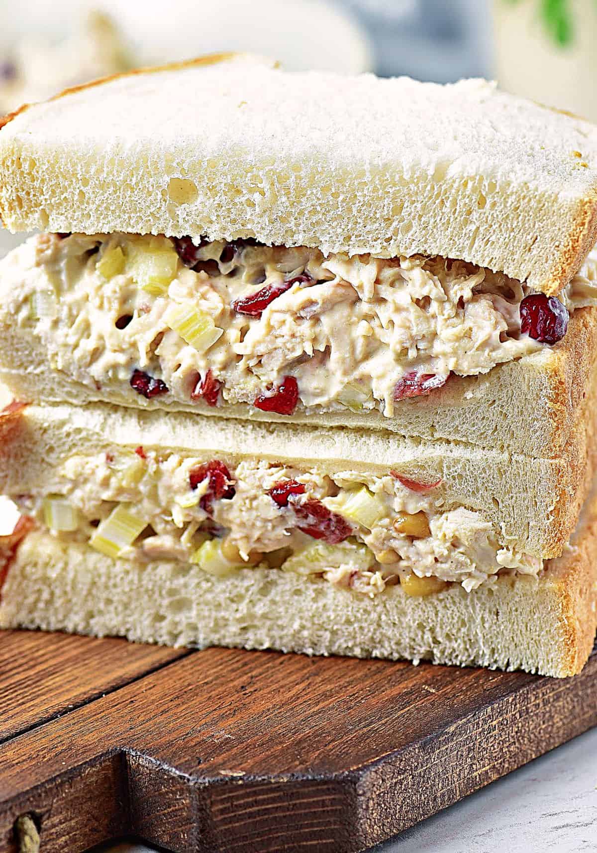 Wooden board with chicken salad with cranberries salad.