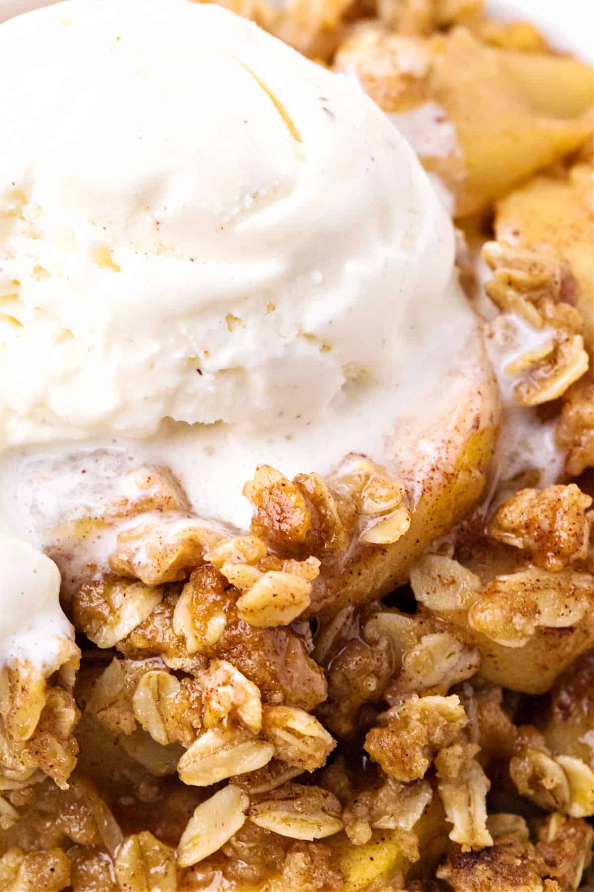 Scoop of ice cream on apple crisp. Close up image.