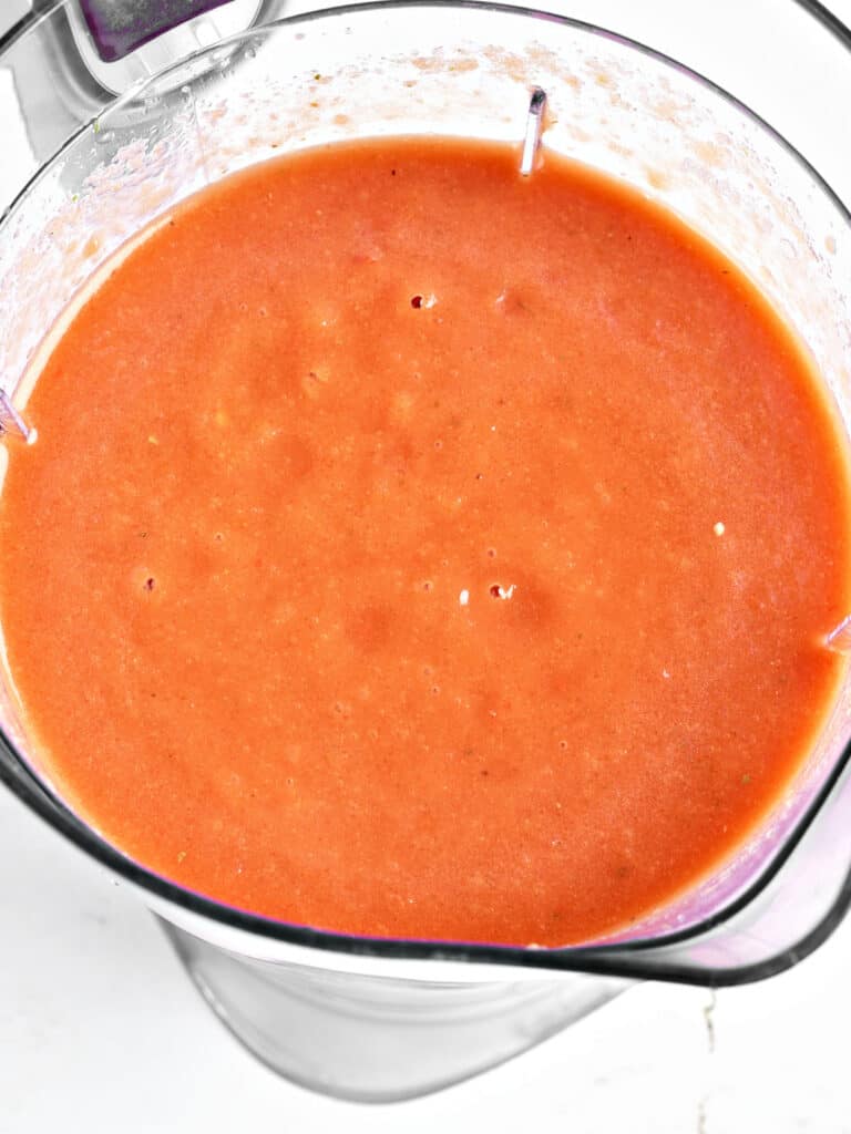 Blender jar with smooth gazpacho mixture.