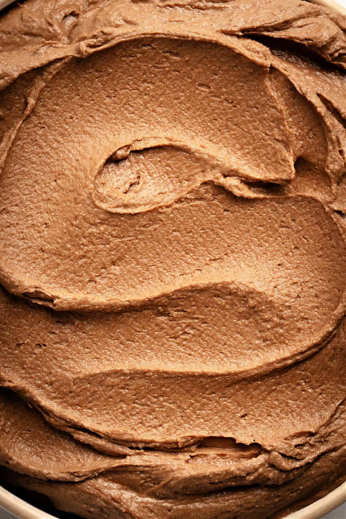 Very close up image of chocolate frosting.