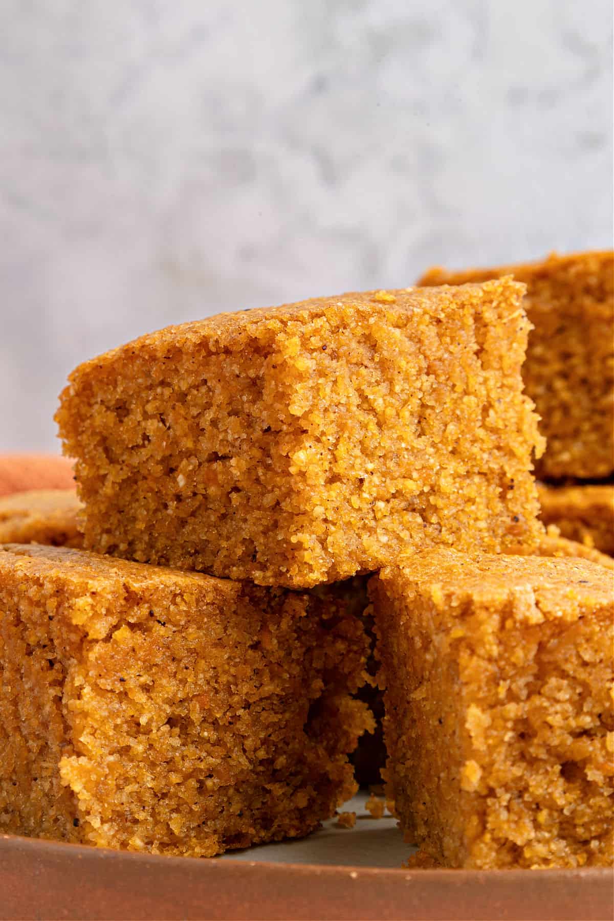 Short stack of sweet potato squares. Gray background.