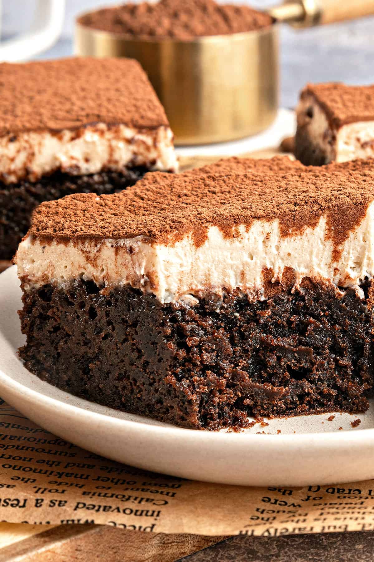 Close up tiramisu brownie square on a white plate.