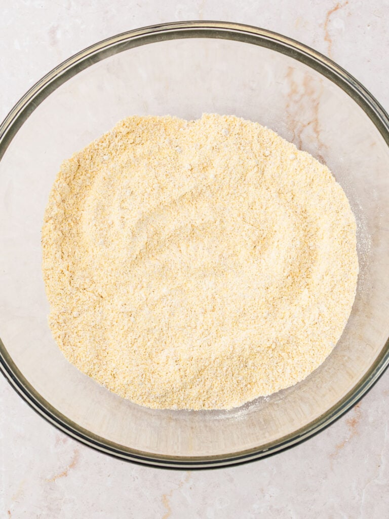 Cornmeal mixture for muffins in a glass bowl. 