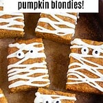 Black, brown and white text overlay on pumpkin mummy blondie bars.