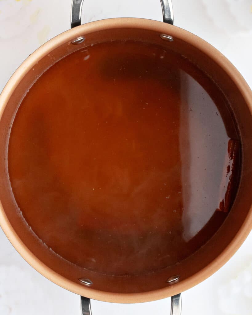 Cooked apple cider tea mixture for wassail. Copper pot.