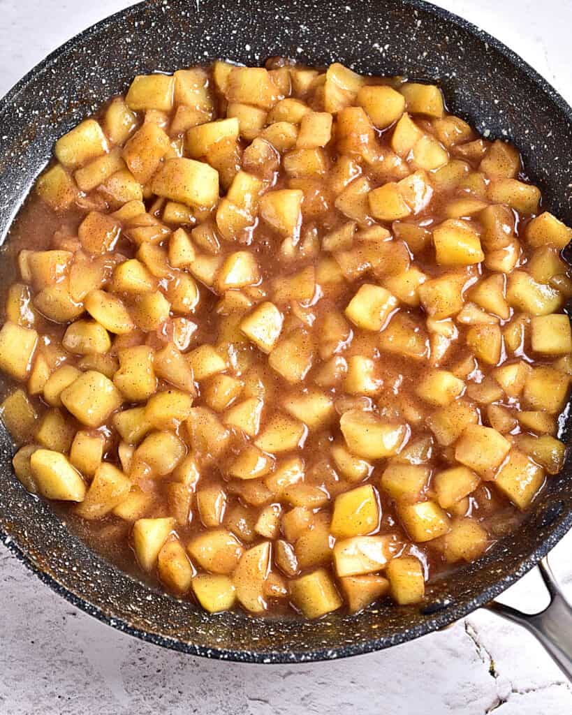 Gray skillet with apple pie filling.