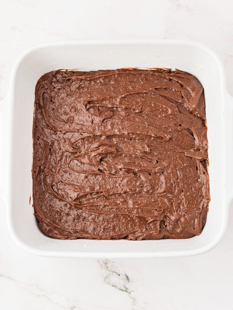 Brownie layer on square ceramic white dish. Top view.