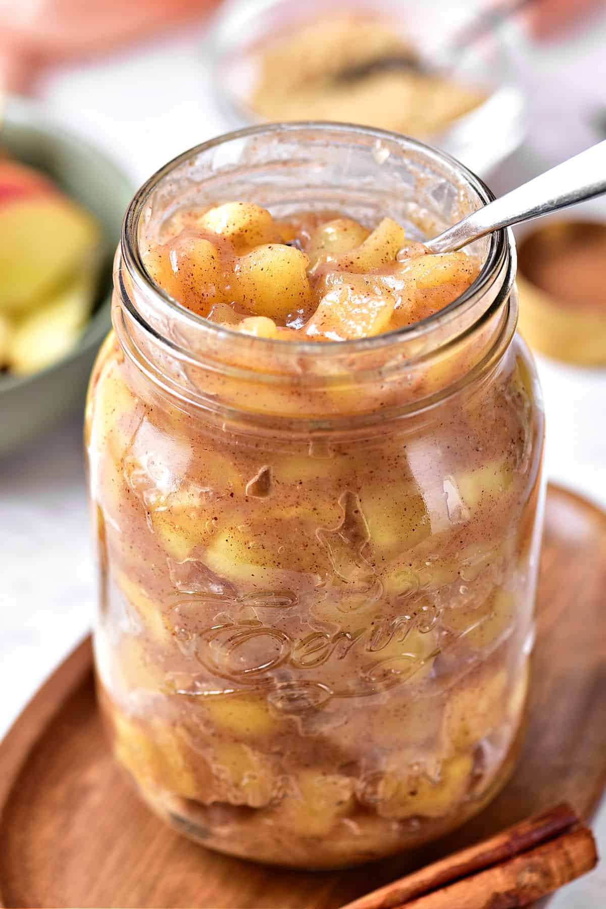 Easy apple filling and topping in a jar. Silver spoon inside.