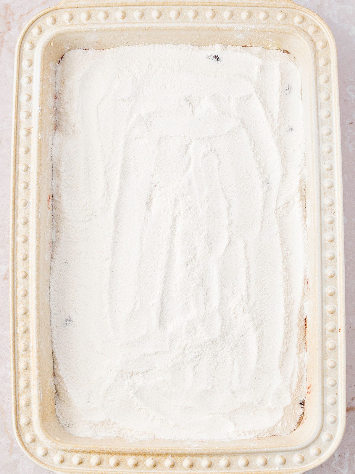 Cake mix topped rectangular cream-colored ceramic dish.