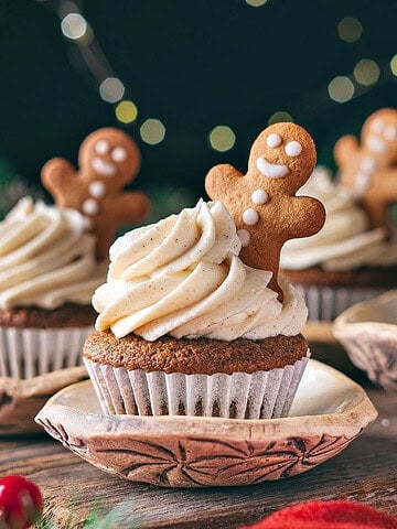 Wooden surface with frosted gingerbread cookies. Dark background. Cookie decorations.