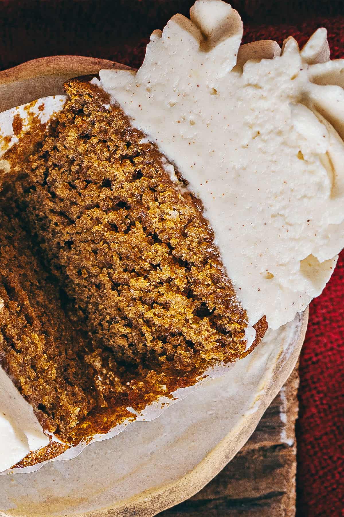 Halved frosted gingerbread cupcake. Close up view.