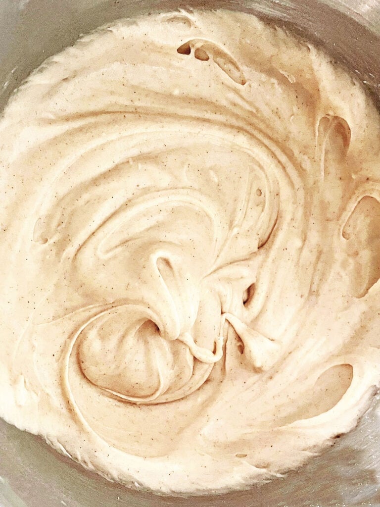 Cream cheese gingerbread frosting in a metal bowl.
