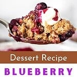 Purple, white and brown text overlay on dish and spoon with blueberry crisp.