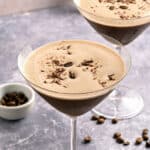 Purplish background with two chocolate espresso martini glasses.