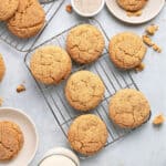 Several crackly snickerdoodles on wire racks. Light gray surface.
