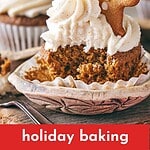 Bitten ginger cupcakes with decorated cookie and frosting. White paper liner. Text overlay.