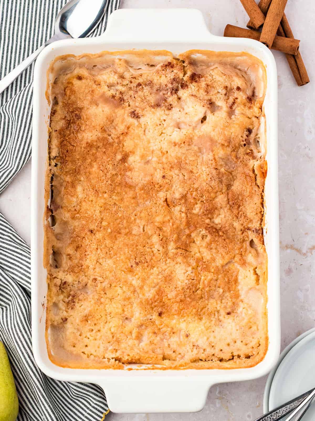 Baked pear dump cake in a white rectangular dish.