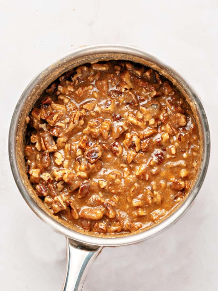 Metal saucepan with pecan praline mixture.