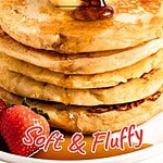 Yellow, brown and red text overlay on pancake stack with syrup and strawberries.