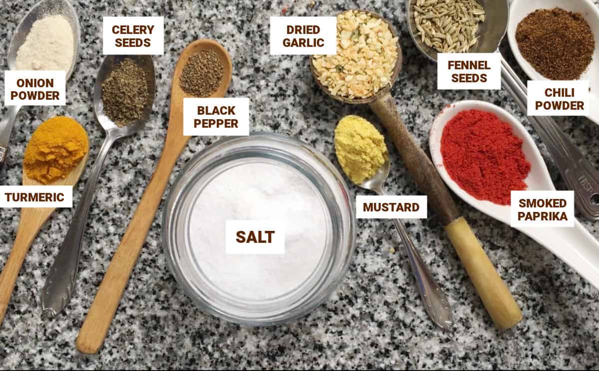 Grey counter with spoons holding spices. Bowl of salt.