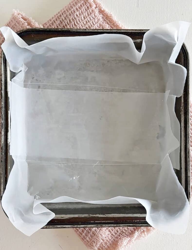 Lined square metal pan with freezer sheets. Top view.