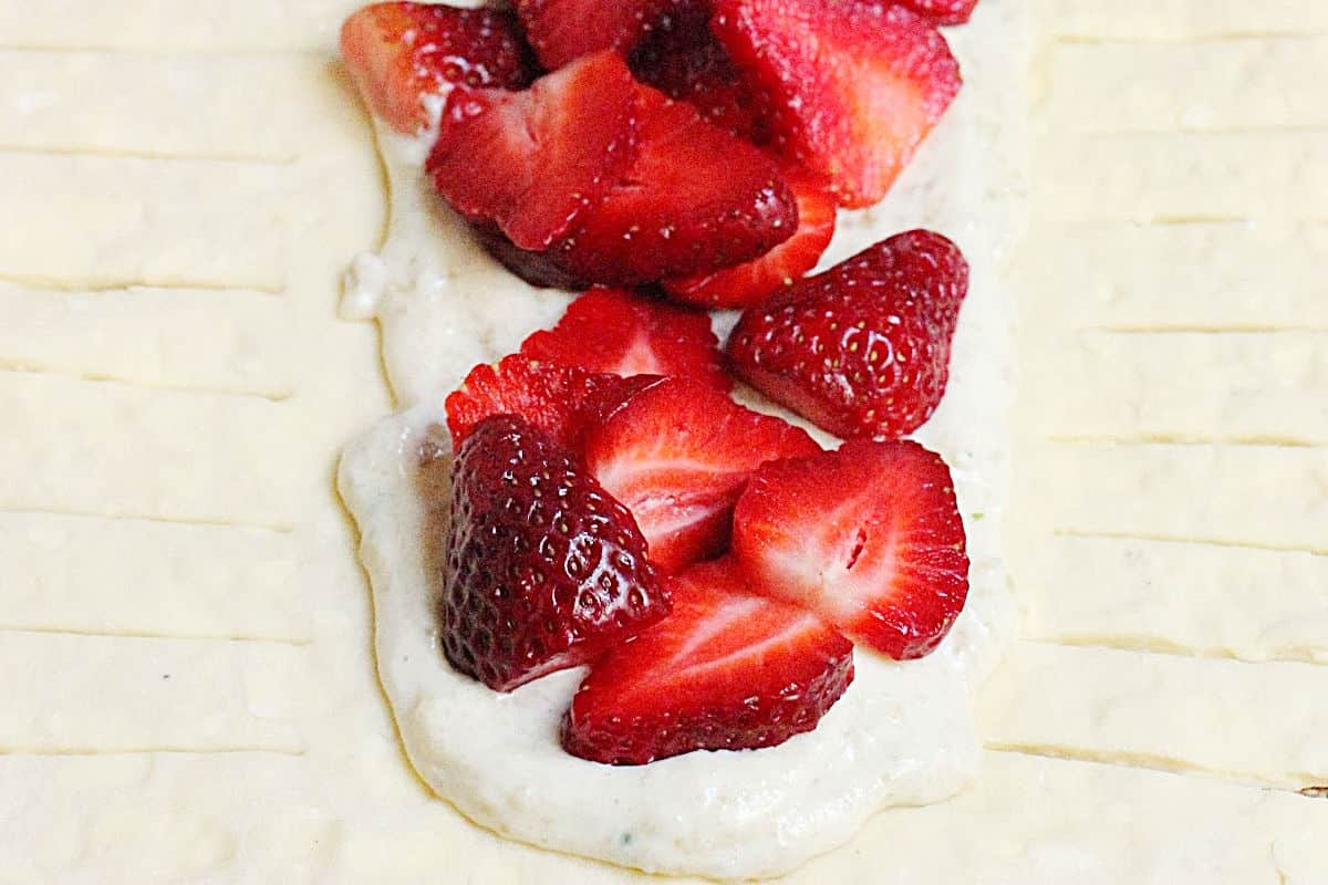 Open unbaked danish braid with strawberry cream filling.