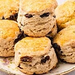 Green and brown text overlay on pile of raisin scones.
