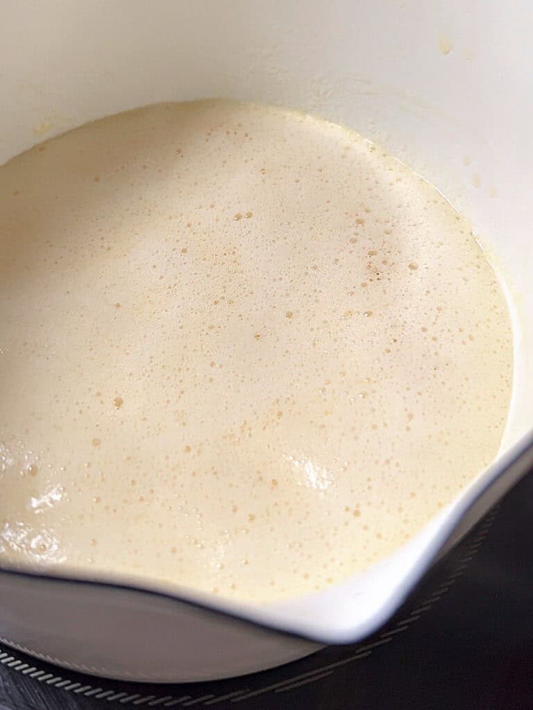 Foamed butter in a white saucepan.