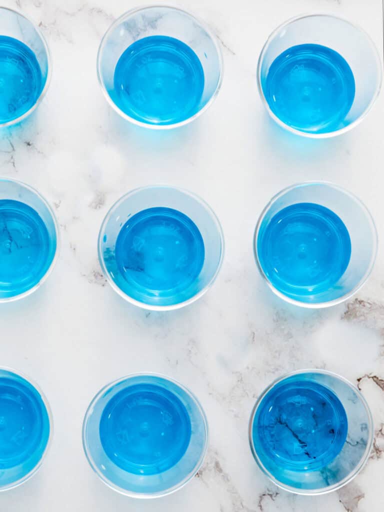Plastic cups with layer of blue gelatin.
