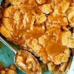 Brown and teal text overlay over a baking dish with fresh apple caramel dump cake.