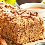 Slice of glazed applesauce crumb cake. Beige plate. Brown and green text overlay.